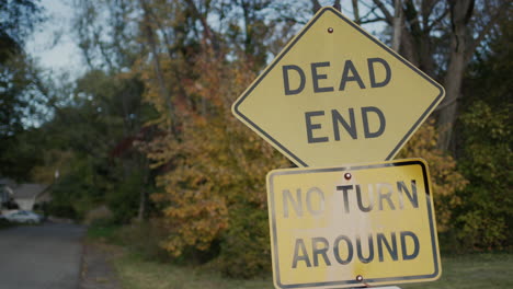 Dead-end-sign-and-No-turn-Aroundon-a-country-road-near-the-forest,-where-the-entrance-to-the-residential-area.-NY,-USA