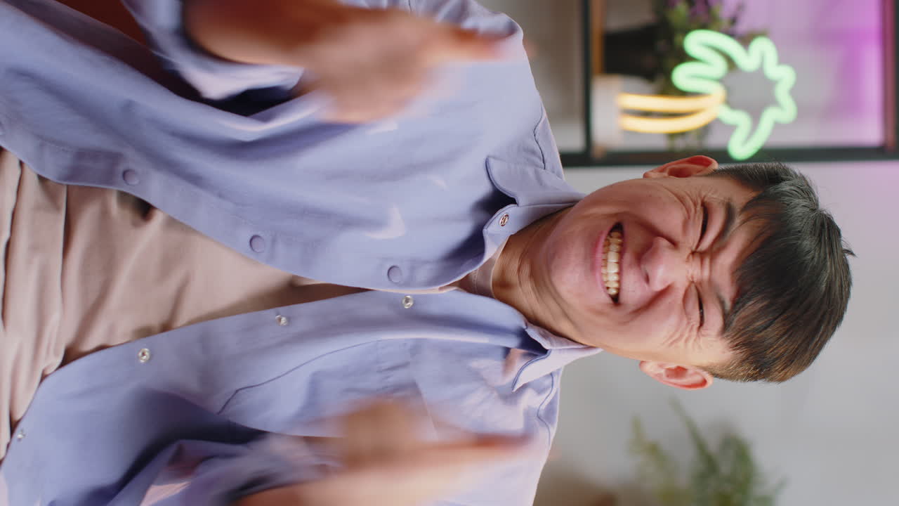 Excited happy asian man surprised shocked by sudden victory good win news celebrating wow reaction