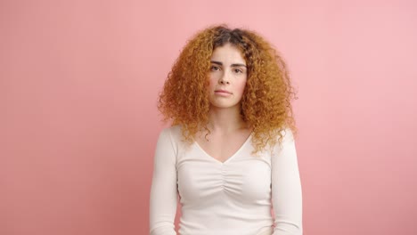 young woman showing different facial expressions on pink background