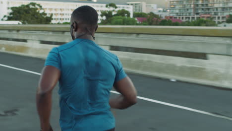 city, fitness or black man running on road