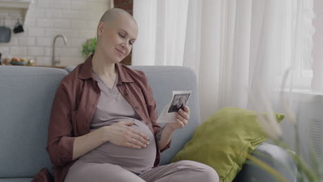 pregnant woman looking at ultrasound photo