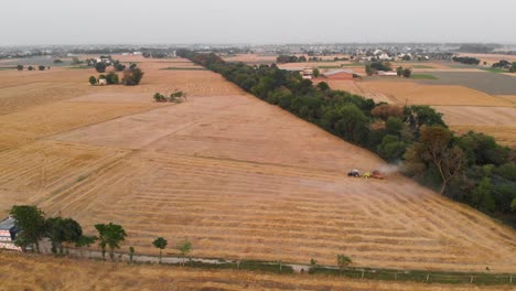 Farmer-cutting-remains-of-the-wheat-crop-and-preparing-farm-for-the-next-crop