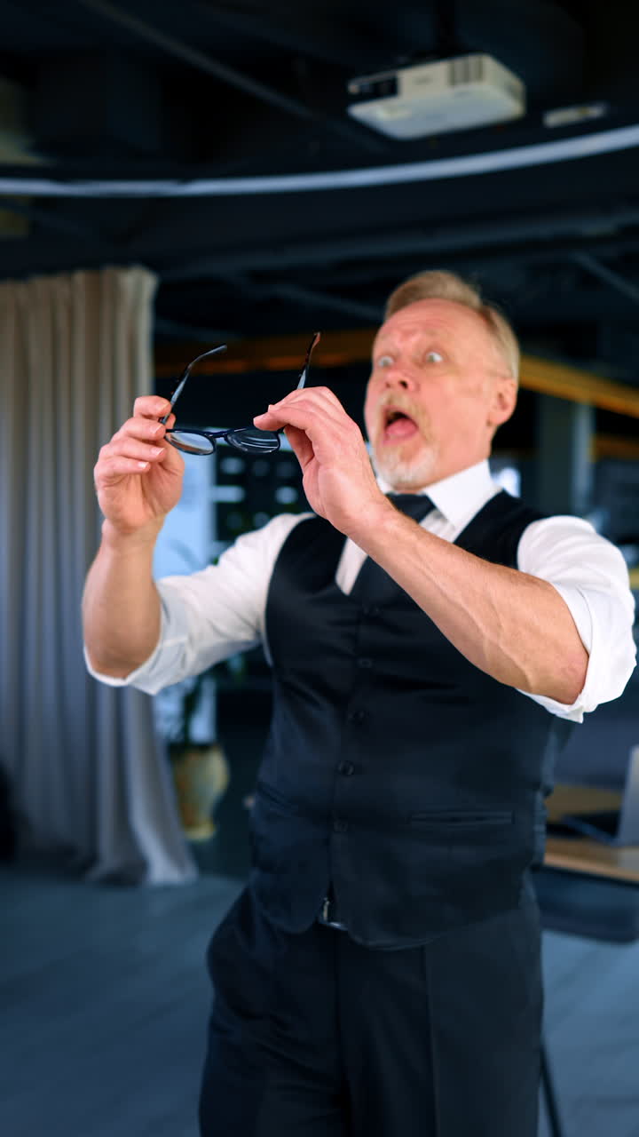 Old man seeing nothing without his eyeglasses. Blind man puts on glasses feeling relief looking around and being surprised by the view. Vertical video.