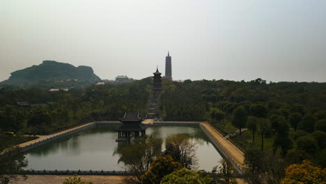dense tropical nature and pond in bai dinh pagoda buddhist temples in ninh binh province, vietnam. aerial shot