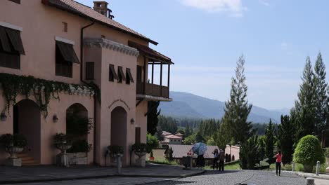 people gathering outside a villa with mountain views