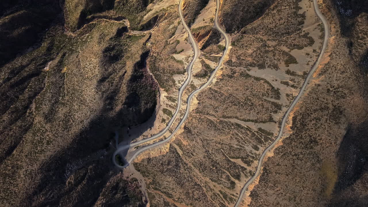 Aerial view of winding Caracoles de Villavicencio road in Mendoza, Argentina, scenic mountain pass popular for tourism