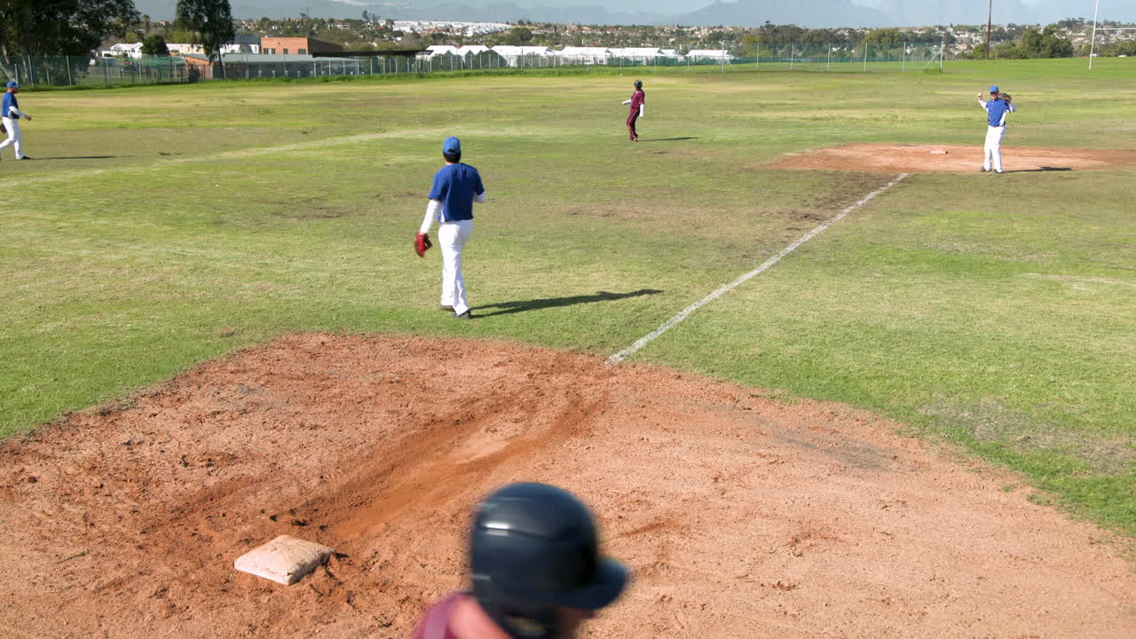 Playing baseball, pitcher throwing ball while batter running to first base