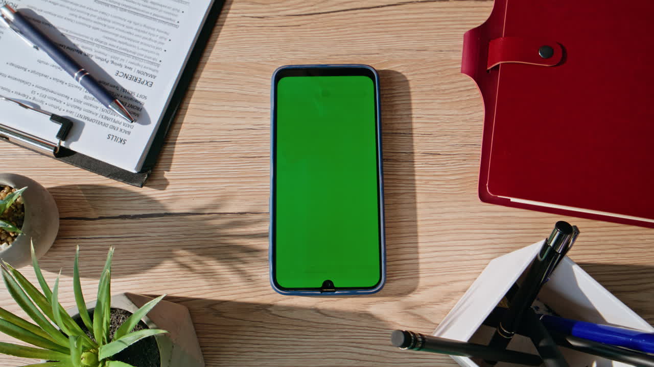 Hands zooming mockup cellphone at organized home workplace closeup. Man touching