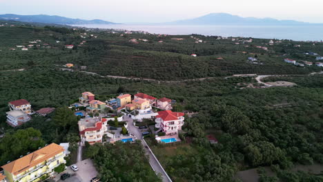 Aerial-View-Of-Town-Surrounded-With-Green-Lush-Vegetation---Drone-Shot