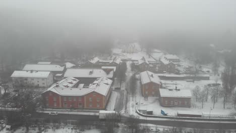 mysterious cloudy misty town covered in fog, yellow church and cars on street, aerial