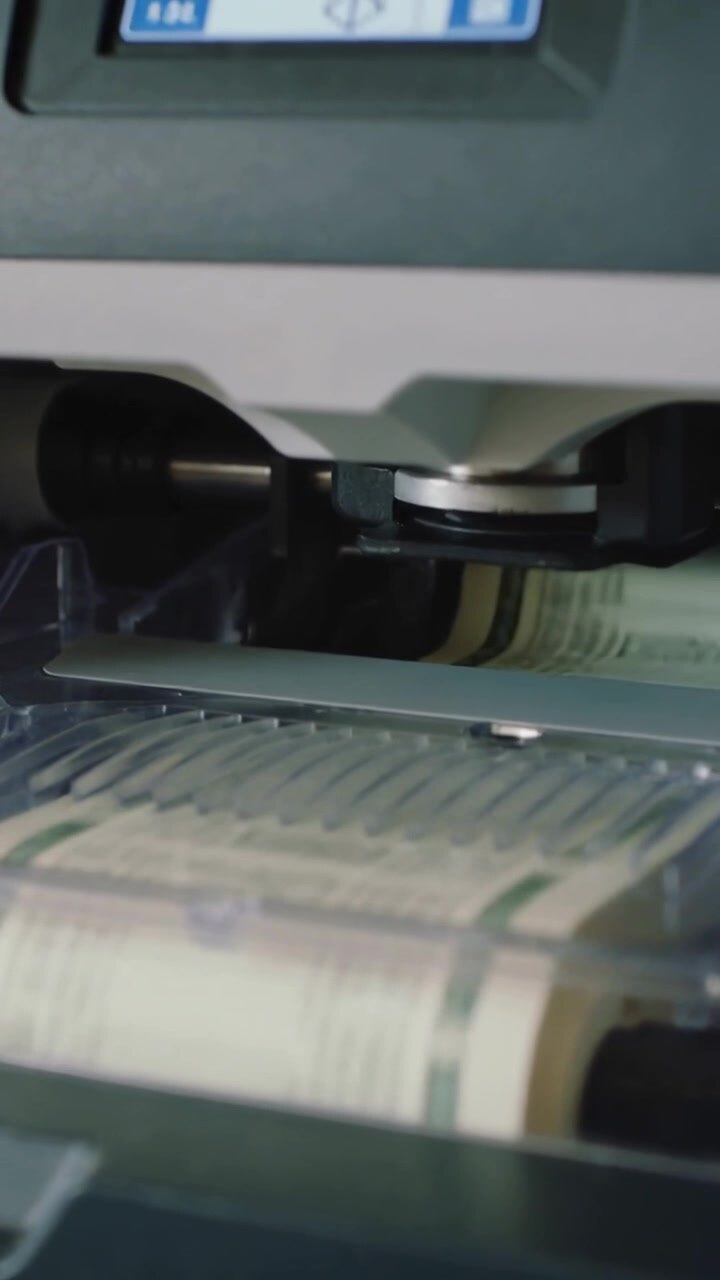 Vertical video: Sending command, panel driving actuator, feeding banknotes on tray in lab for audit