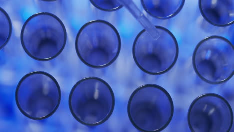 video of laboratory pipette and test tubes with copy space on blue background