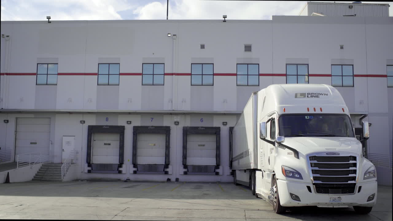 Brown Line Semi-Truck at a Warehouse Loading Dock