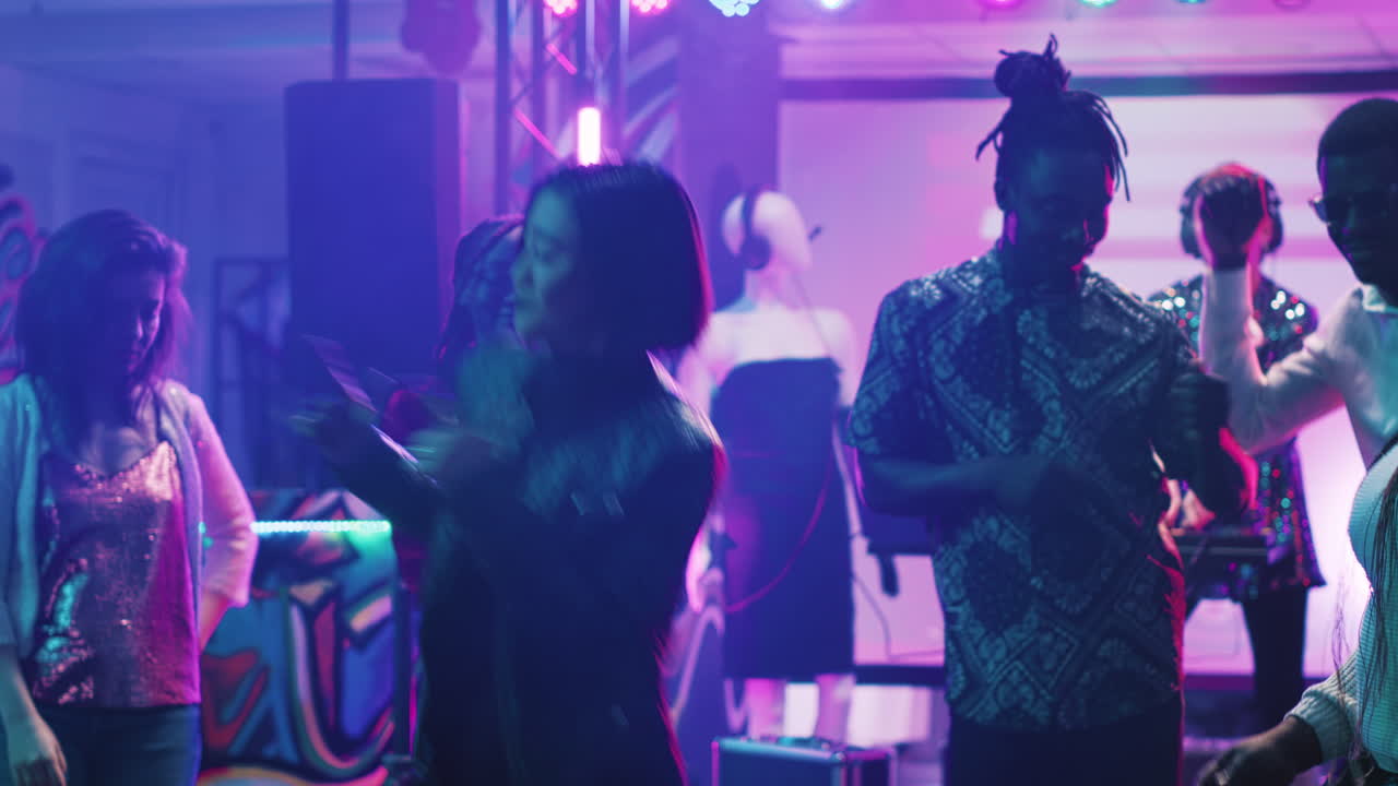 Group of people dancing at a party in a club