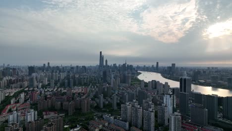 drone aerial view of buildings, cityscape and river in downtown