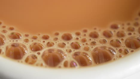 Close-up-of-cup-of-milk-tea-on-table-,