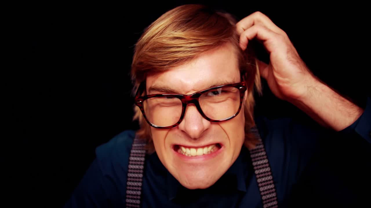 Geeky businessman typing on keyboard