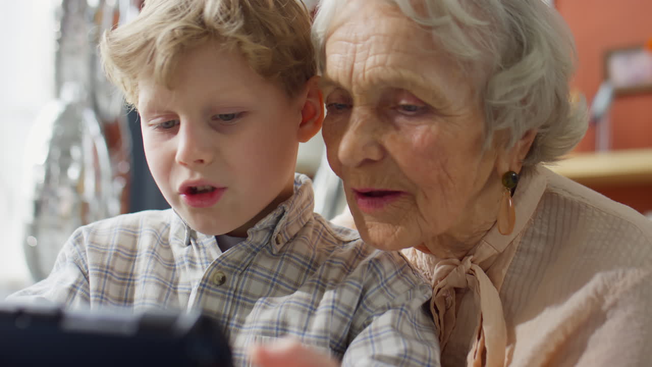 Grandchild and Grandmother Using Tablet Together