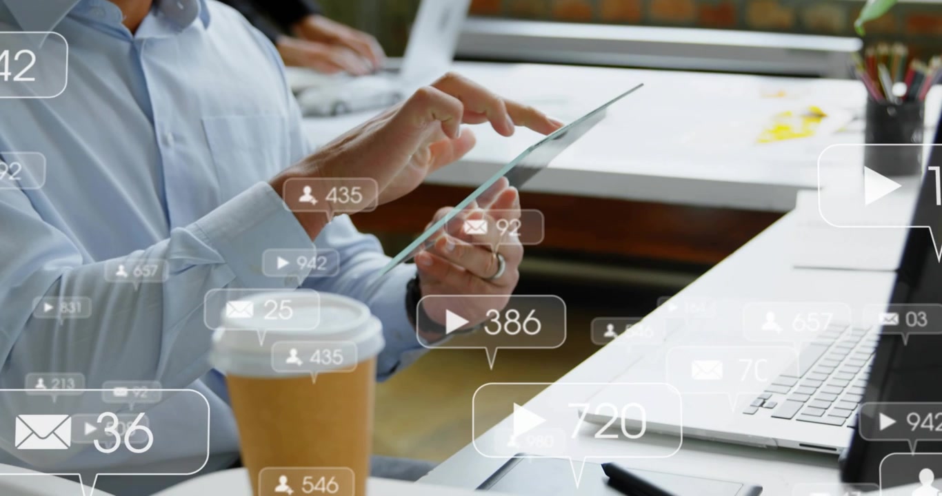 Mid adult man tapping tablet and checking animated social media metrics changing for marketing data