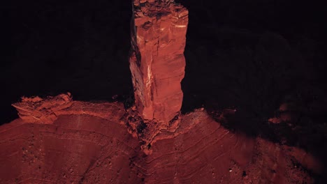 aerial flyover tilts to small peak of moab rock spire, castleton tower