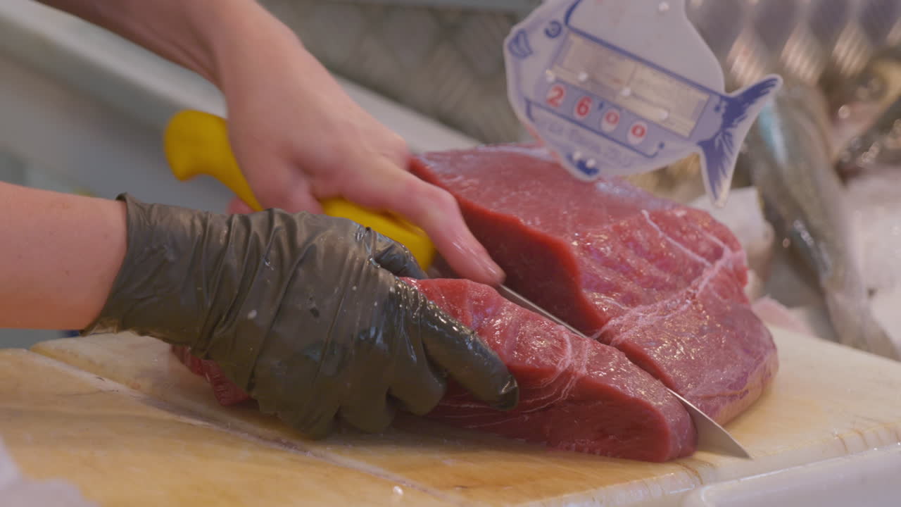 Process of cutting a piece of bluefin tuna, at the Barbate Food Market