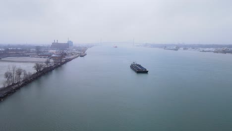 aerial view of steel barge on detroit river transporting materials on a foggy day
