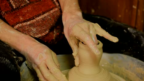 professional male potter making mug in pottery workshop