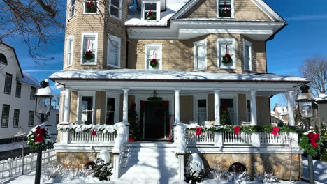 charming victorian home decorated with christmas wreath and garland