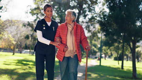 nurse assisting elderly woman in the park
