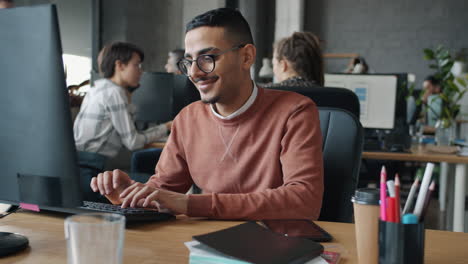 man working on computer in office