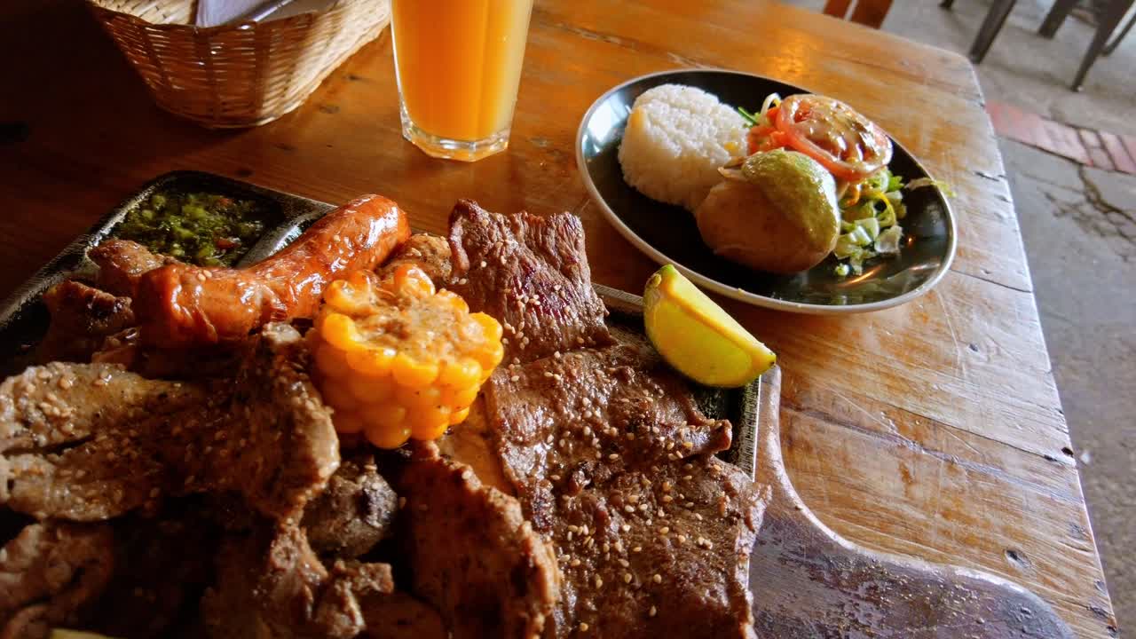 POV Colombian style grill on a hot surface with sausage and meat in the tourist town of Guatavita, Colombia