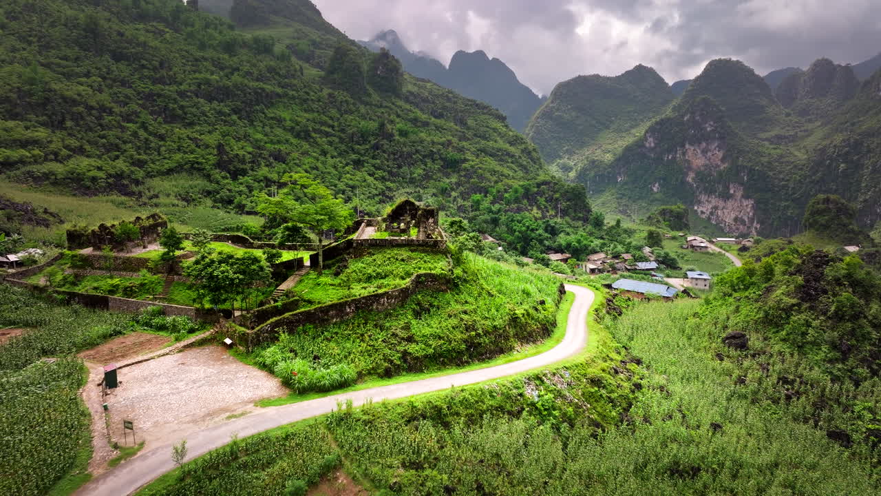 Aerial dolly over French Colonial Castle Military Post in verdant Vietnam valley