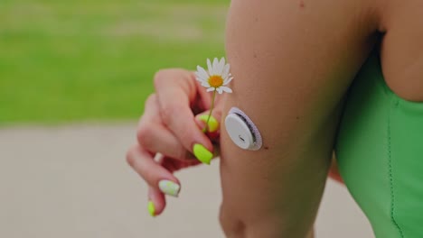 futuristic lifestyle showing cgm patch with flower as symbol of biohacking trend