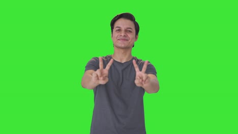 Happy-Indian-man-showing-victory-sign-Green-screen