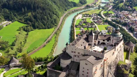 Aerial-view-of-Hohenwerfen-Castle,-with-river-and-town-in-the-background,-Austria,-Europe