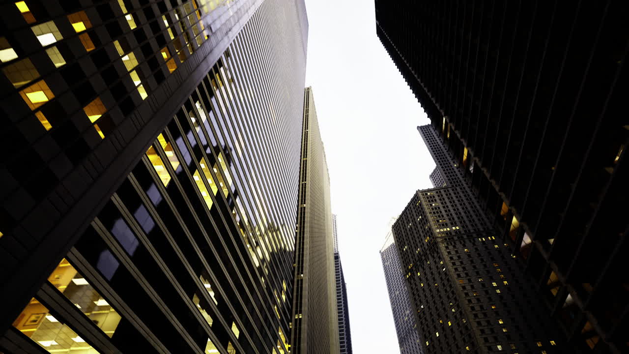 Explore the towering skyscrapers reflecting evening light in the city