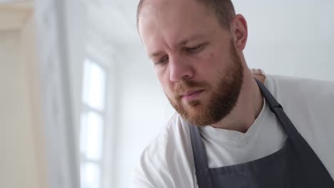the artist creates a picture on a white canvas using plaster creating an abstract picture the artist creates a picture on a white canvas using plaster the process of creating an abstract painting by an artist