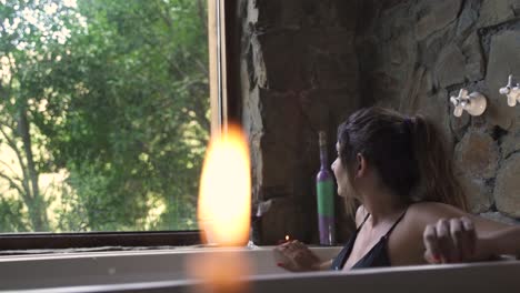 4K-Young-attractive-female-having-a-fancy-bath-in-a-jacuzzi-with-big-green-nature-window