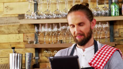 waiter at counter using digital tablet