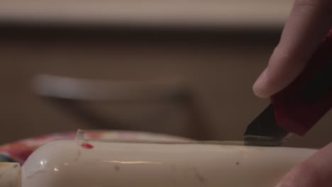 Cutting-Vertically-The-Empty-Plastic-Bottle-With-A-Sharp-Knife---Close-Up-Shot