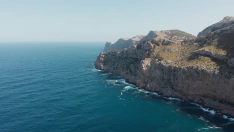 Picturesque-Landscape-Of-Rocky-Limestone-Cliffs-At-Cala-Figuera-Surrounded-By-The-Calm-Blue-Sea-In-Summer-In-Santanyi,-Majorca-In-The-Balearic-Islands-Of-Spain