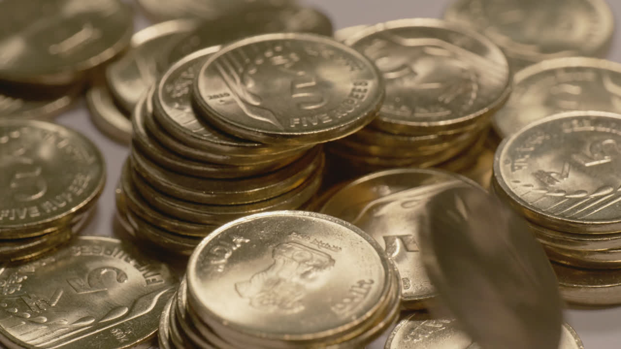 falling coins on indian currency shining golden 5 rupee coin towers , 4k ,close up, Parallax shot