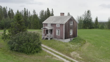 4k drone shot of a lonely wooden house in the woods in sweden