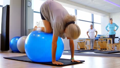 mujer mayor haciendo ejercicio con la pelota de ejercicio 4k