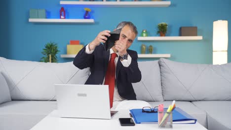 Home-office-worker-man-showing-his-empty-wallet-to-the-camera.