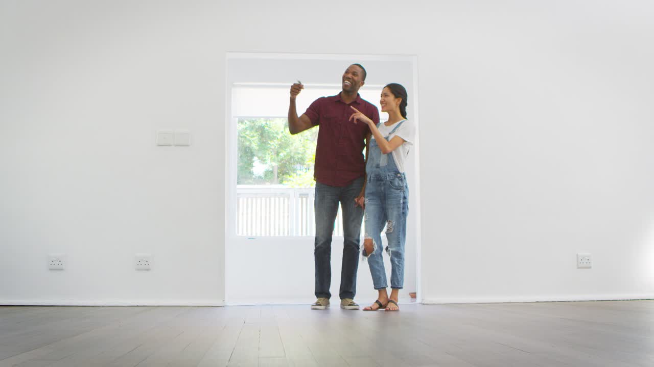 Excited Young Couple Moving Into New Home Together
