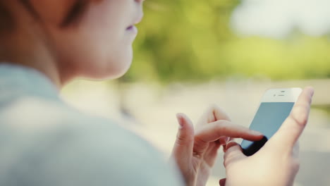 woman using phone outdoors showing future of sustainable technology