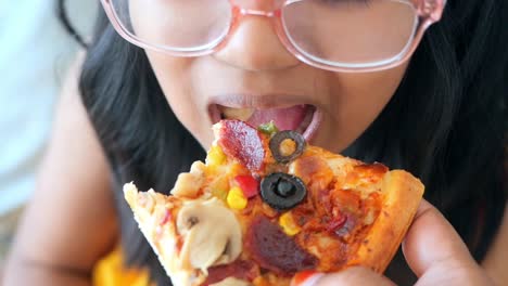 child eating pizza