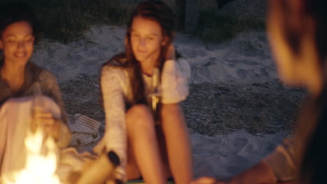 friends enjoying a night at the beach campfire