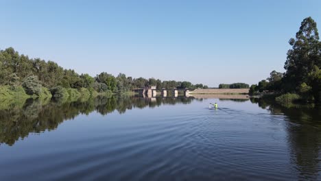 footage-of-a-man-canoeing-at-a-dam